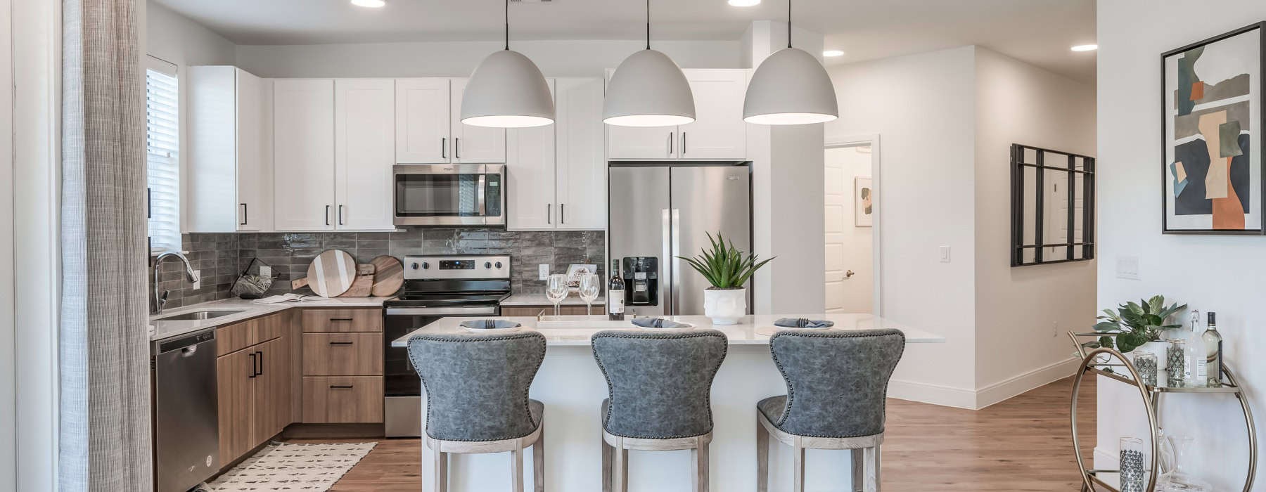 look into the kitchen area with pendant lighting over the kitchen island