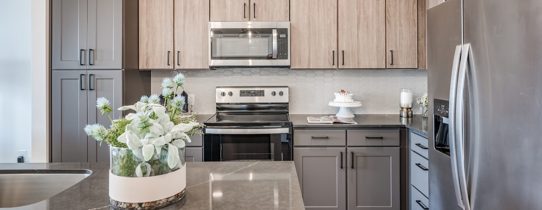 a kitchen with wood cabinets and an island with a plant